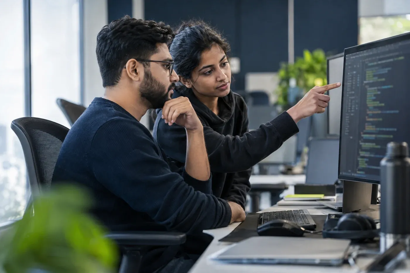 Illustrative QA engineers reviewing automated tests together